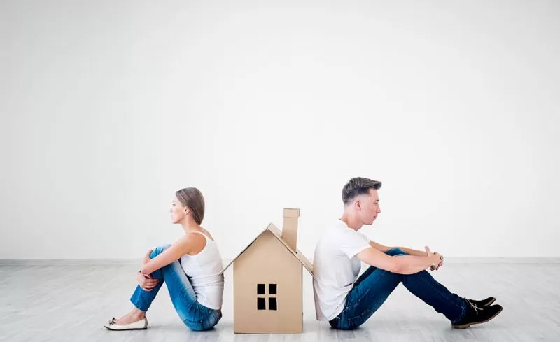 Quarrelling couple with cardboard house